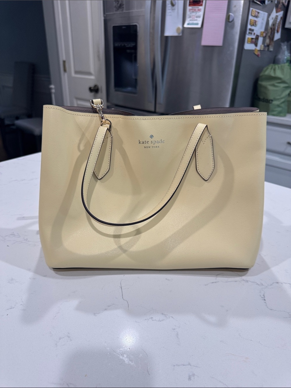 kate spade Cream Leather Tote with Top Handles. Color is butter.